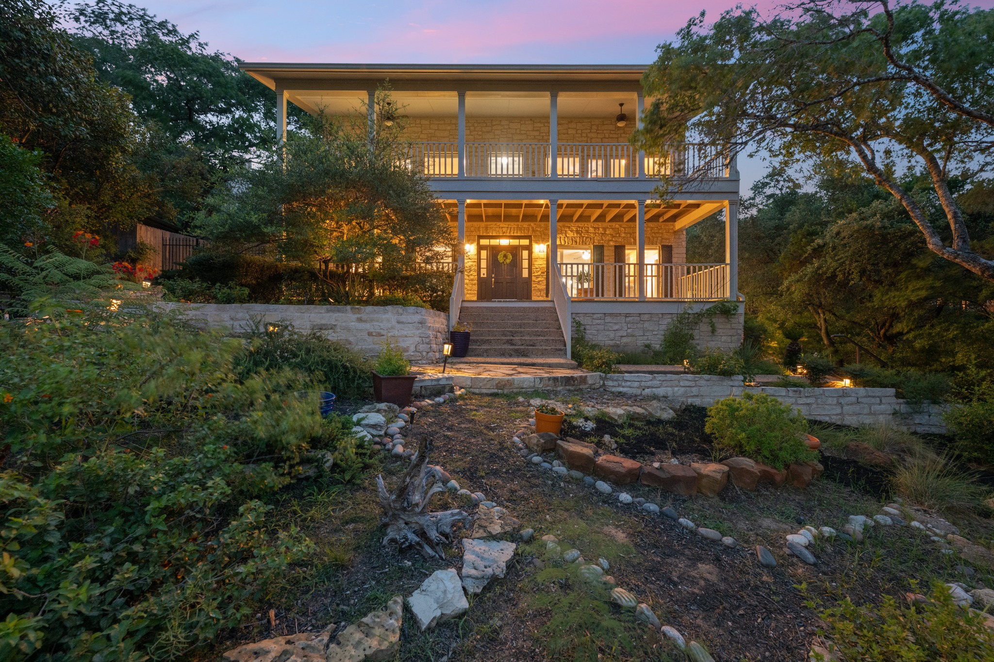 6004 Mt Bonnell Road Austin, TX 78731 - Photo 1 of 24 a front view of a house with garden