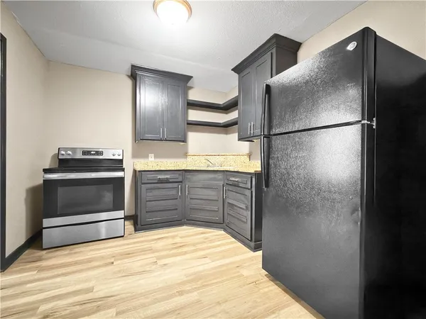 a kitchen with a refrigerator and a stove