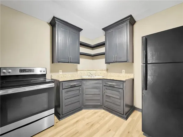 a kitchen with stainless steel appliances granite countertop a refrigerator and a stove