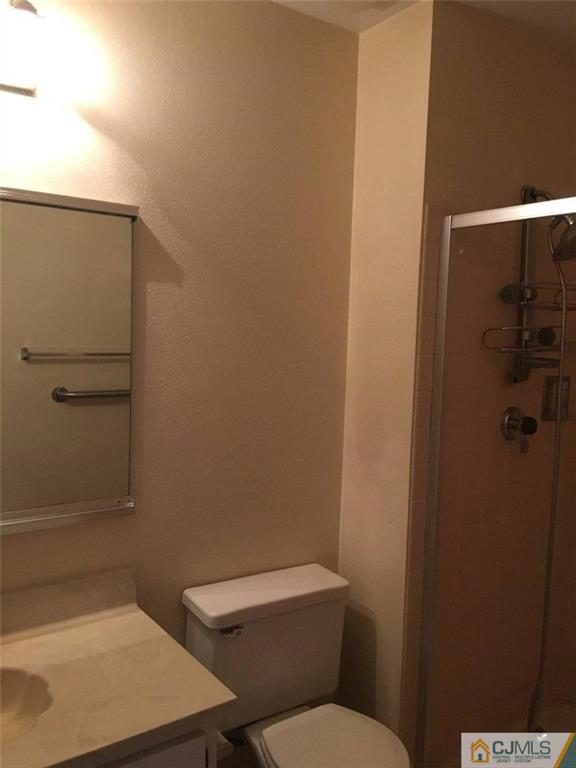 440 B Belford Road Monroe Township, NJ 08831 - Photo 11 of 13 a white toilet sitting next to a shower