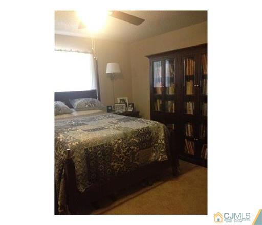 440 B Belford Road Monroe Township, NJ 08831 - Photo 7 of 13 a bedroom with a bed and a mirror