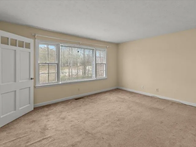 a kitchen with white cabinets appliances and sink