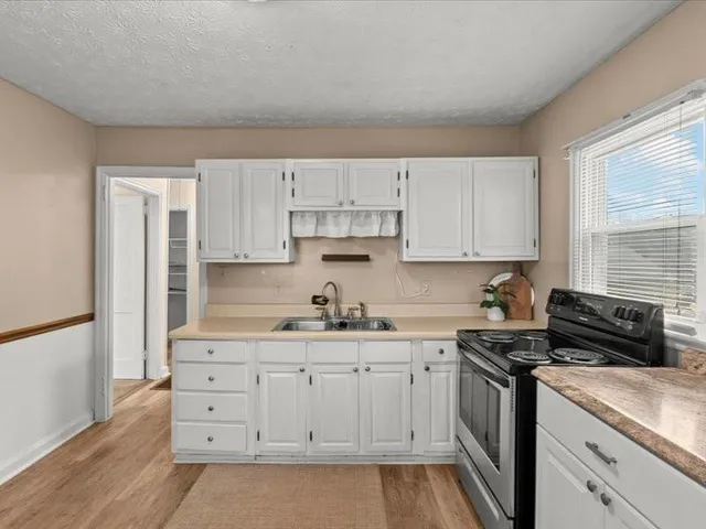 a kitchen with stainless steel appliances a refrigerator sink and cabinets