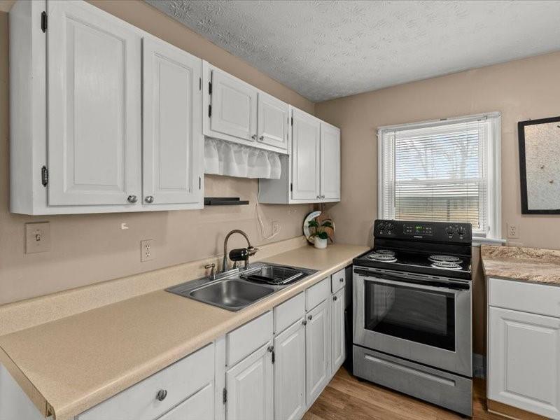 4624 Macland Road Hiram, GA 30141 - Photo 15 of 30 a kitchen with white cabinets and white appliances