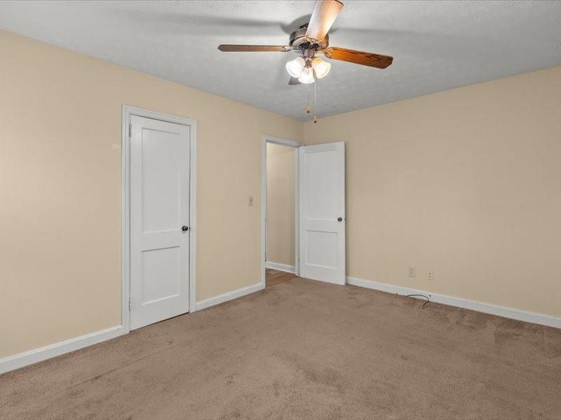 4624 Macland Road Hiram, GA 30141 - Photo 20 of 30 an empty room with a chandelier fan and windows