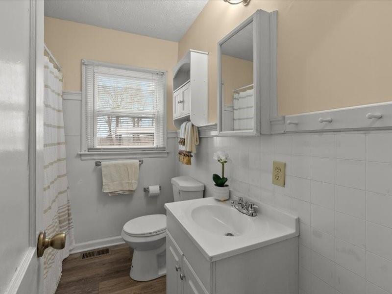 4624 Macland Road Hiram, GA 30141 - Photo 21 of 30 a bathroom with a toilet a sink a mirror and a window