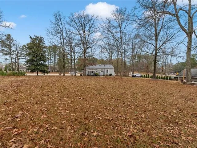 a view of a house with a backyard