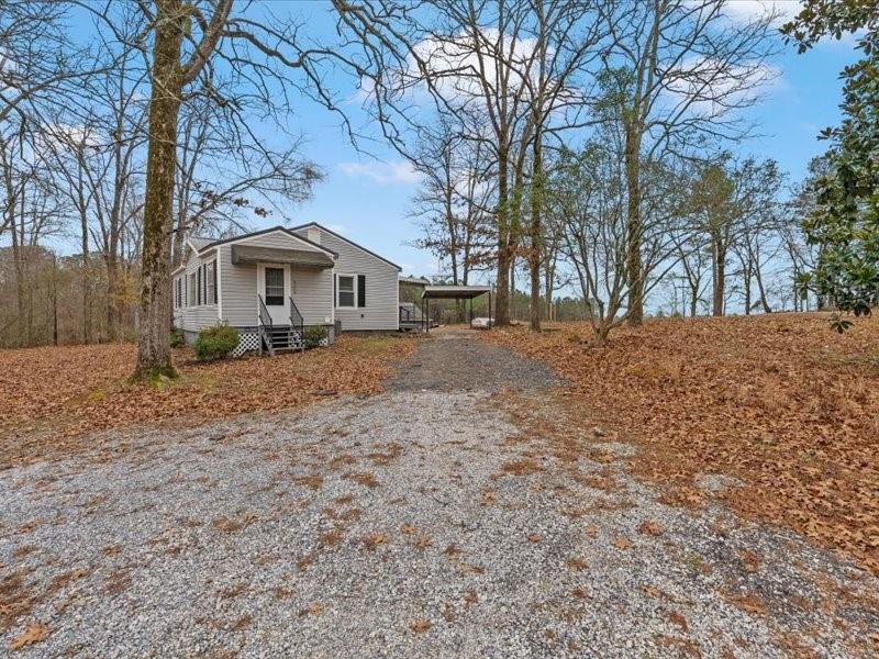4624 Macland Road Hiram, GA 30141 - Photo 7 of 30 a front view of a house with a yard covered in snow