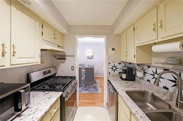 a kitchen with granite countertop a stove and a sink