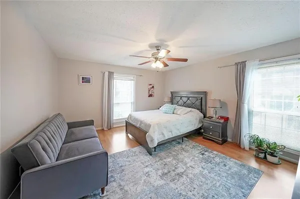 a bedroom with a large bed a chandelier and closet