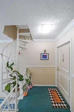 a view of a bedroom with wooden floor and a potted plant