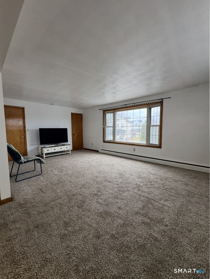 16 Grove Street New London, CT 06320 - Photo 2 of 12 a view of an empty room with a window