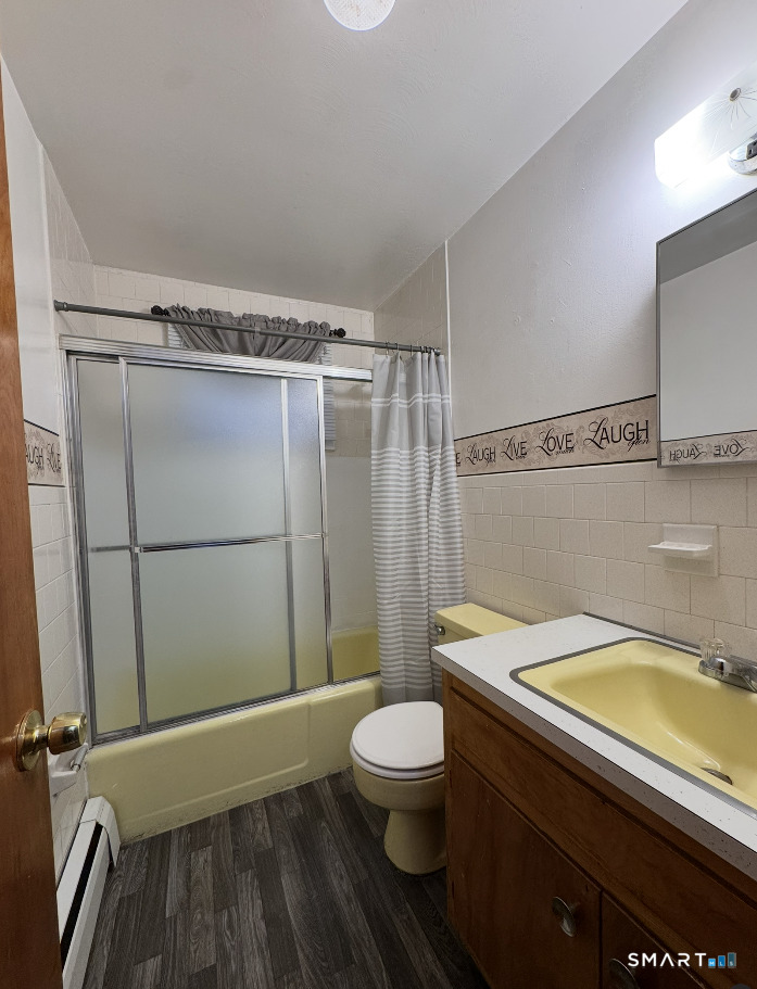 16 Grove Street New London, CT 06320 - Photo 8 of 12 a bathroom with a sink a toilet a mirror and shower