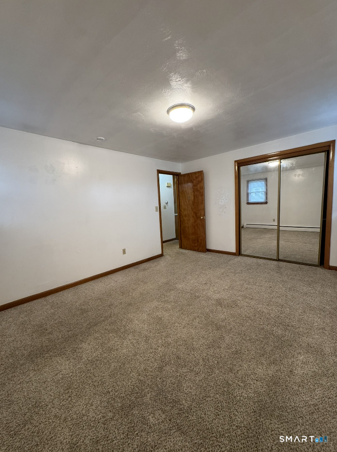 16 Grove Street New London, CT 06320 - Photo 9 of 12 a view of an empty room with a window
