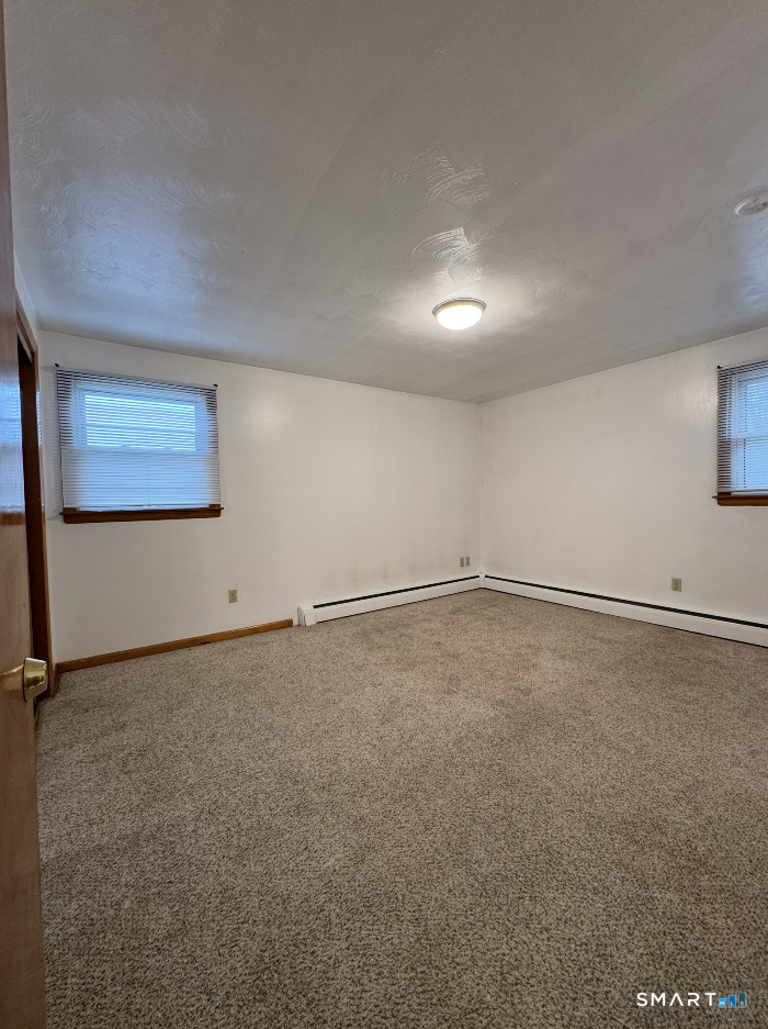 16 Grove Street New London, CT 06320 - Photo 10 of 12 an empty room with a empty space and windows