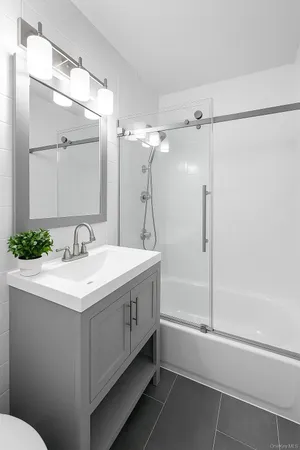 a bathroom with a sink a mirror and a shower