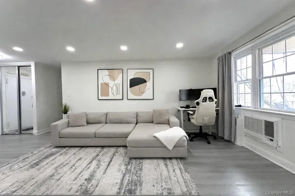 a living room with furniture and a large window