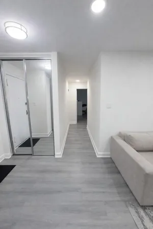 a view of a livingroom with wooden floor and staircase