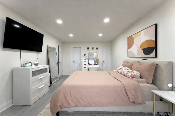 a bedroom with a bed and a flat screen tv