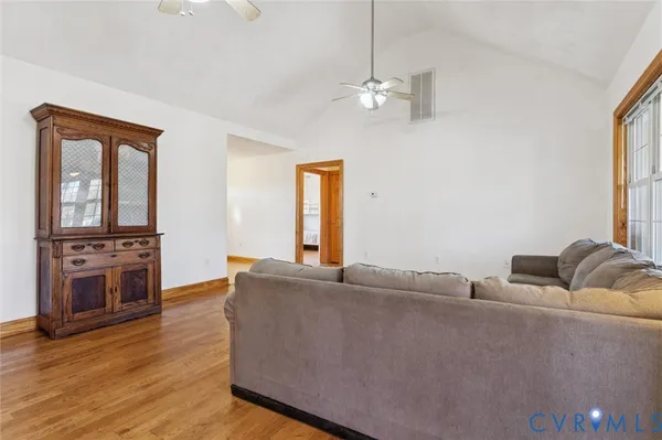 a living room with furniture and wooden floor
