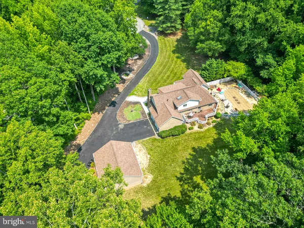 an aerial view of a house with outdoor space and street view