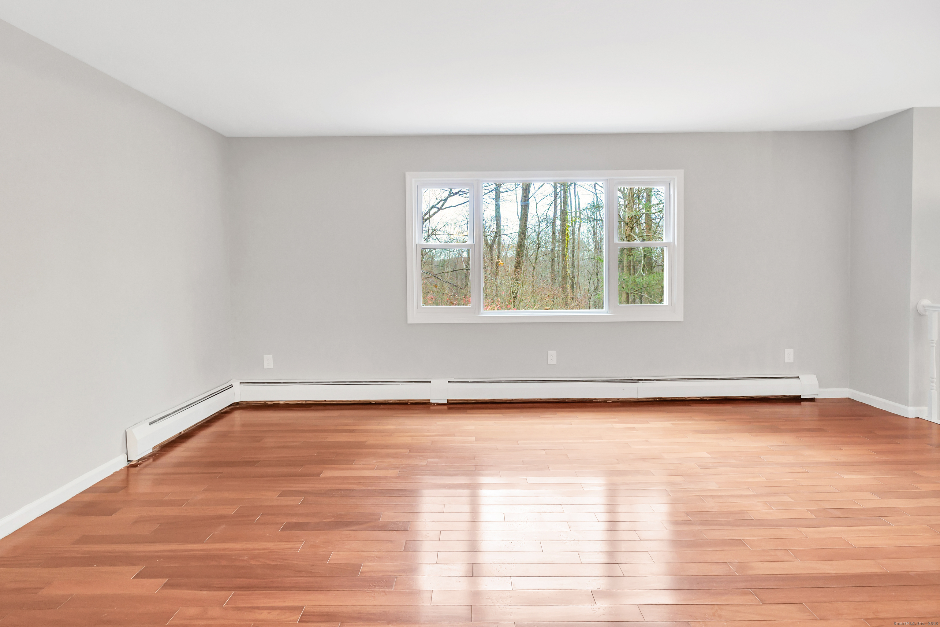 76 Dorman Road Oxford, CT 06478 - Photo 14 of 39 a view of an empty room with wooden floor and a window