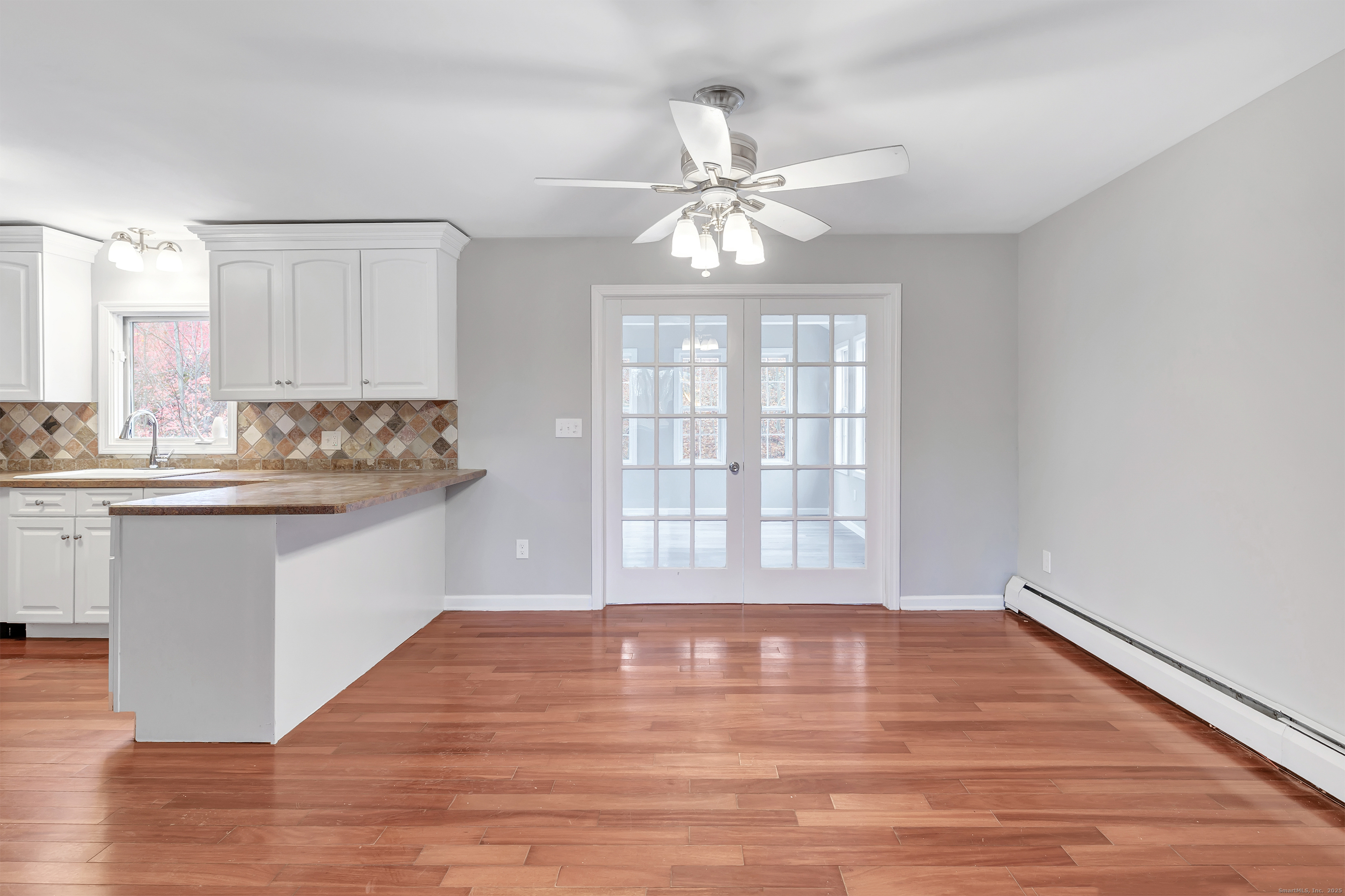 76 Dorman Road Oxford, CT 06478 - Photo 15 of 39 a room with a chandelier fan and wooden floor