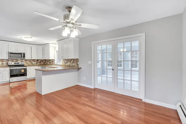 a kitchen with granite countertop a stove top oven and cabinets