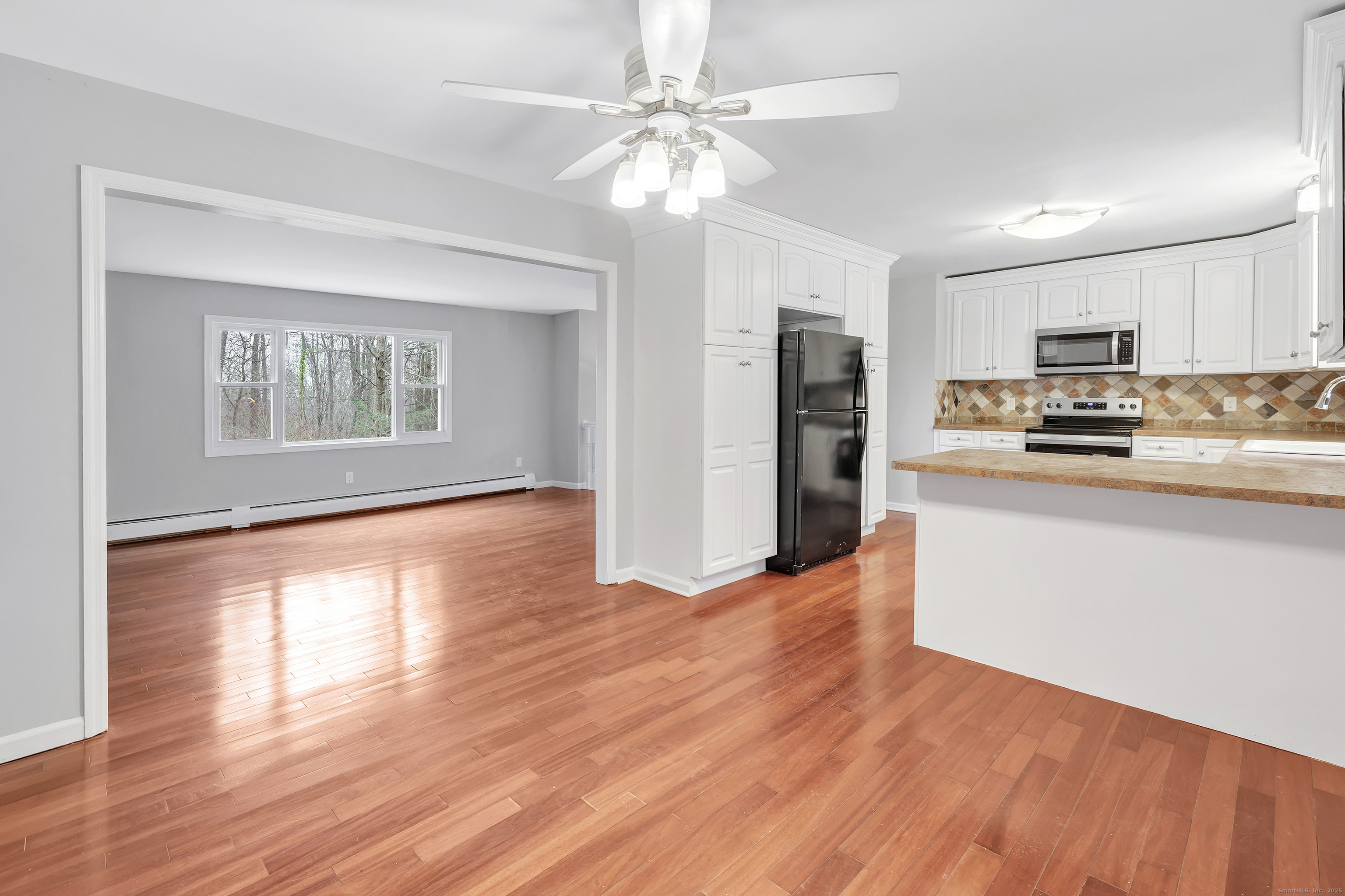 76 Dorman Road Oxford, CT 06478 - Photo 17 of 39 a open kitchen with stainless steel appliances granite countertop a refrigerator stove top oven and cabinets with wooden floor