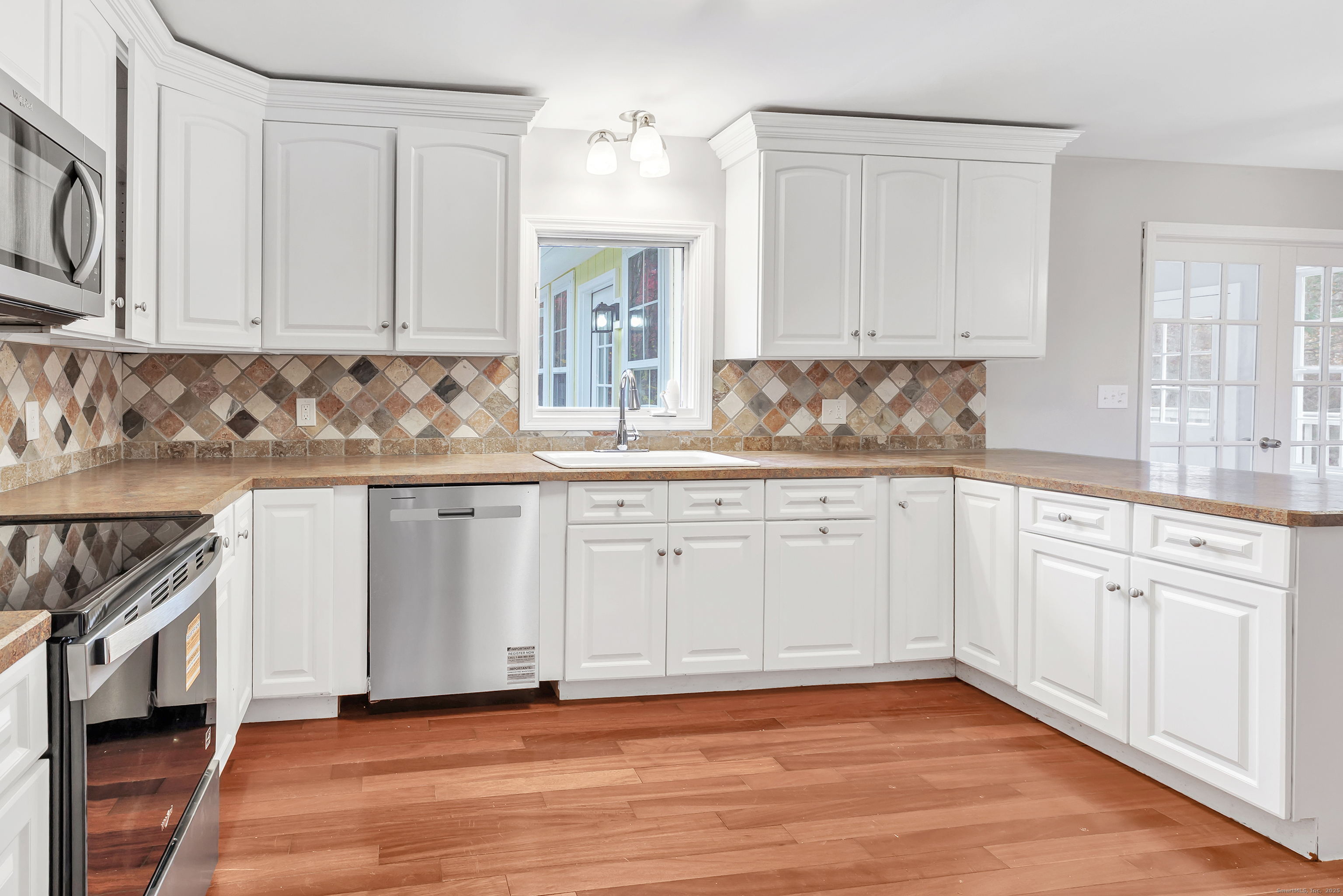 76 Dorman Road Oxford, CT 06478 - Photo 18 of 39 a kitchen with granite countertop white cabinets and a stove