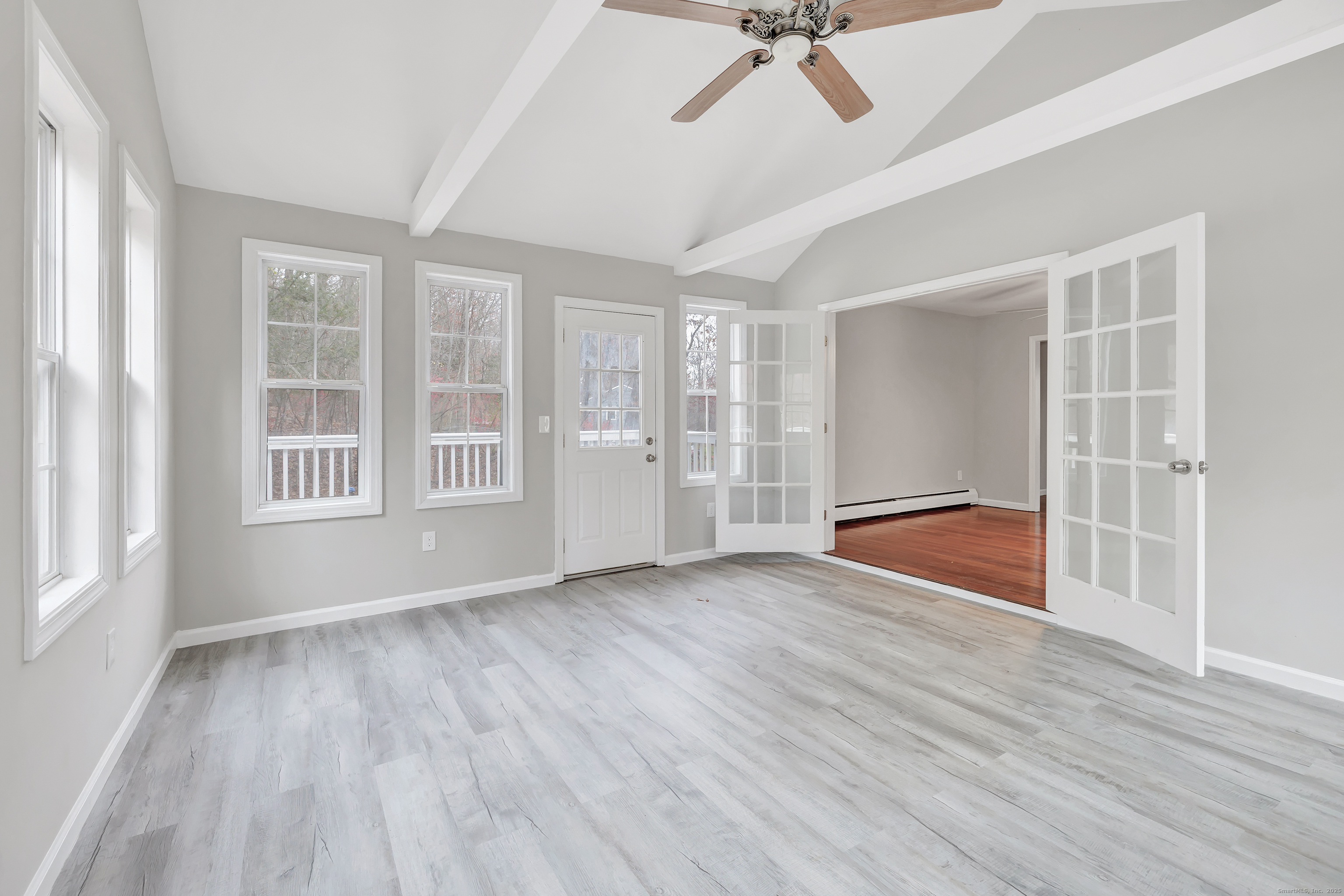 76 Dorman Road Oxford, CT 06478 - Photo 23 of 39 a view of an empty room with a window and wooden floor