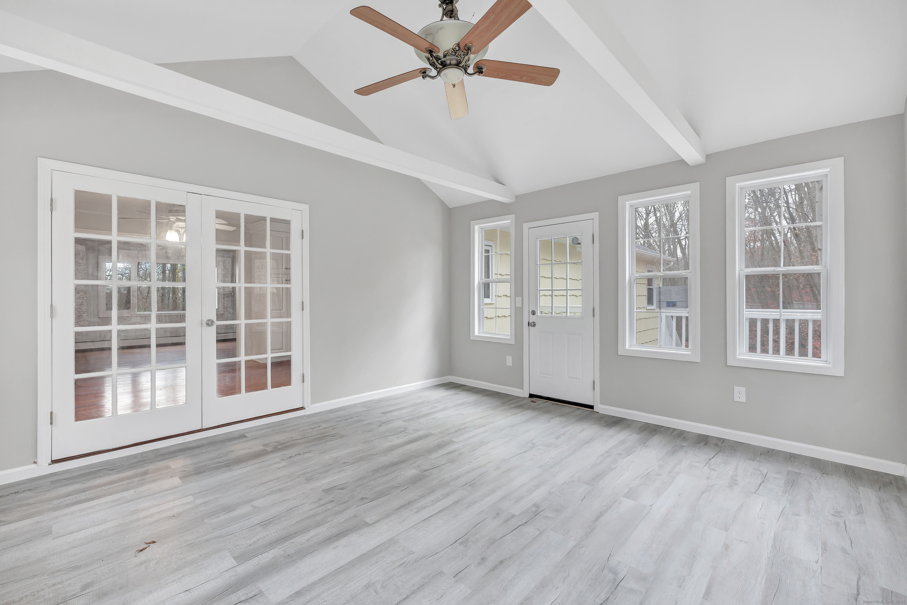 76 Dorman Road Oxford, CT 06478 - Photo 24 of 39 a view of an empty room with a window and wooden floor