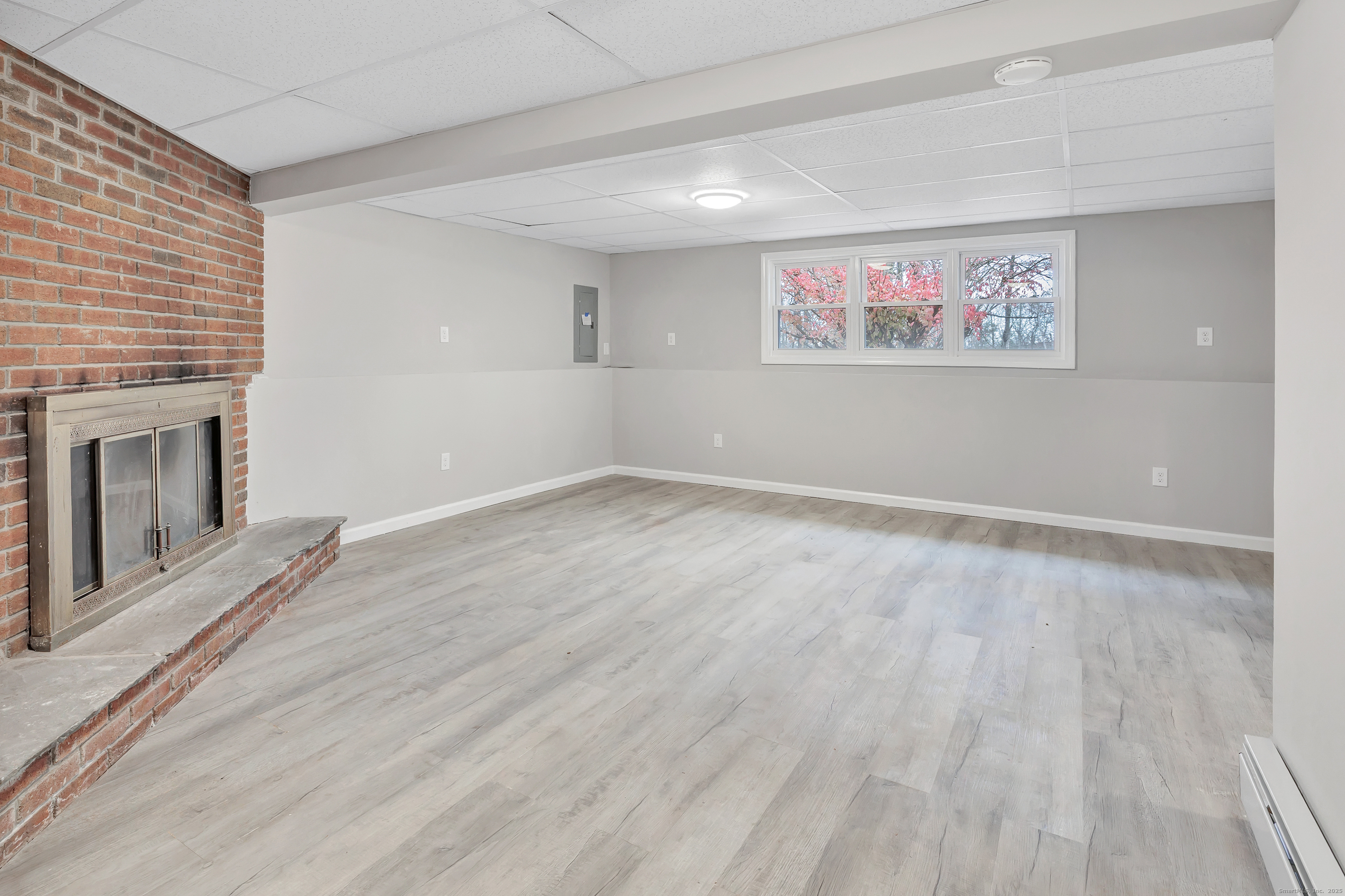 76 Dorman Road Oxford, CT 06478 - Photo 35 of 39 a view of an empty room with wooden floor and a fireplace
