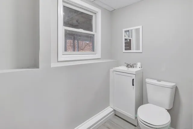 a white toilet sitting next to a bathroom sink