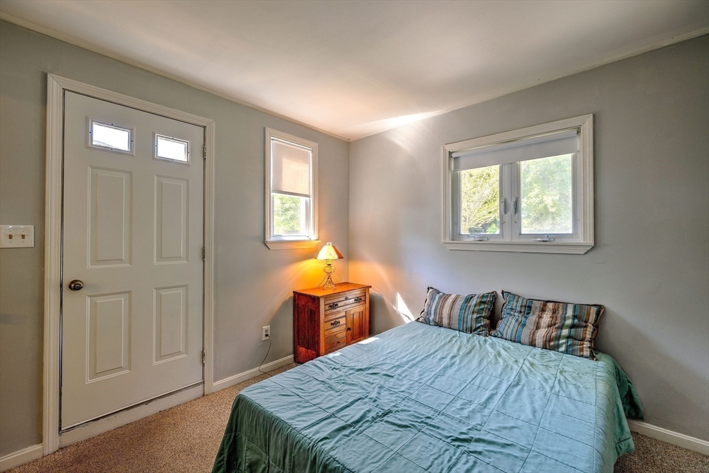 25 Tahanto Road Worcester, MA 01602 - Photo 31 of 35 a bedroom with a bed and a closet with mirror