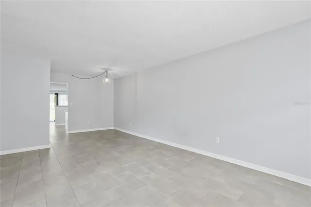 a kitchen with stainless steel appliances granite countertop a refrigerator a stove and a sink