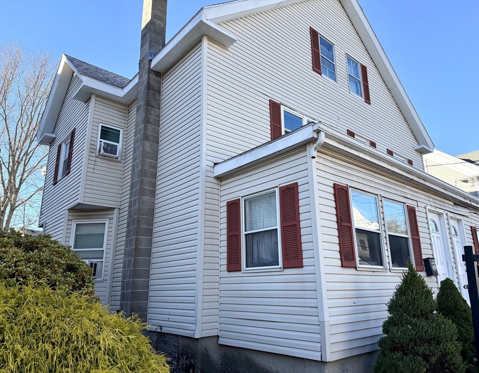 a view of a house with a garage and balcony