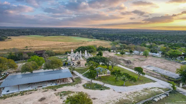 an aerial view of a house with a big yard