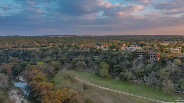 an aerial view of a house with a lake view