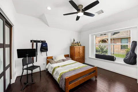 a bedroom with a bed and a window