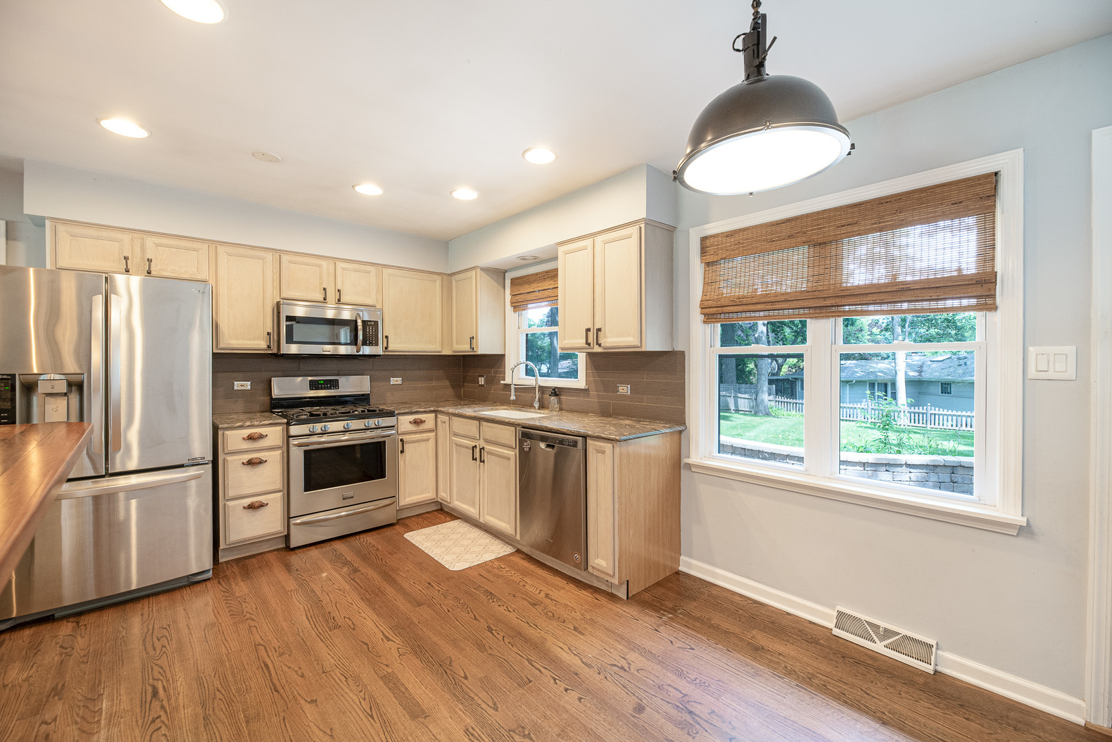 308 Dunbar Road Mundelein, IL 60060 - Photo 8 of 33 a kitchen with granite countertop stainless steel appliances a refrigerator cabinets and wooden floor