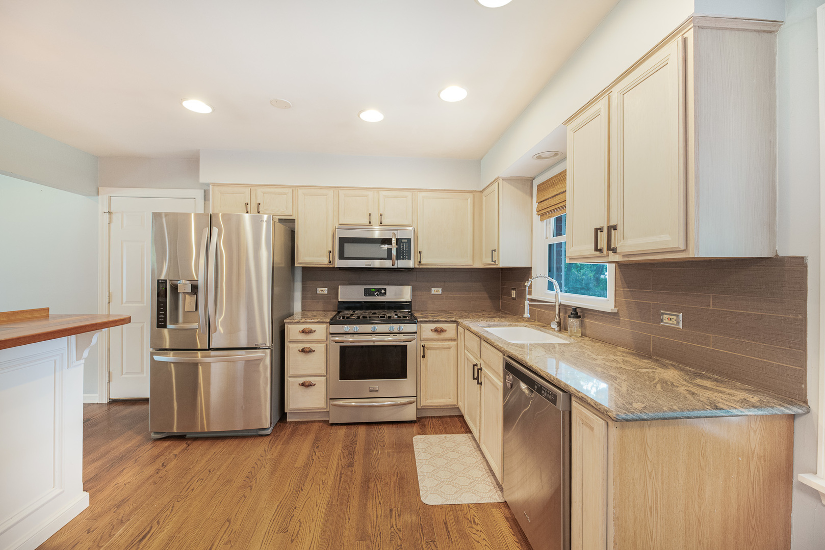 308 Dunbar Road Mundelein, IL 60060 - Photo 9 of 33 a kitchen with stainless steel appliances granite countertop a refrigerator a stove a sink and a microwave