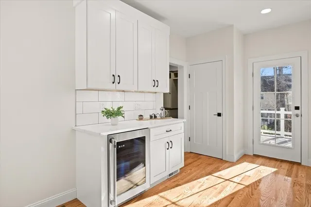 a kitchen with granite countertop white cabinets and white appliances