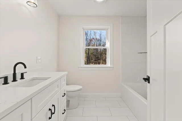a bathroom with a toilet sink and window