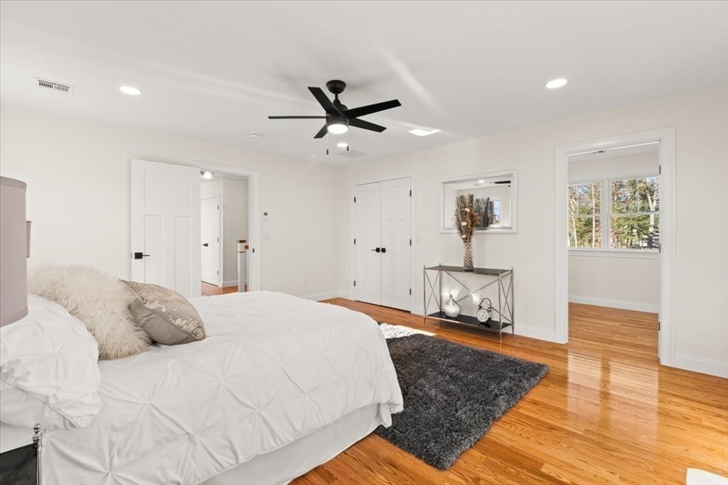 Lot 10 Matthew Circle Easton, MA 02356 - Photo 23 of 33 a bedroom with a bed and a chandelier