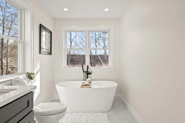 a white bath tub sitting next to a white toilet