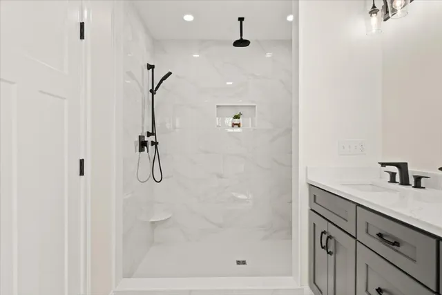 a bathroom with a shower and a sink