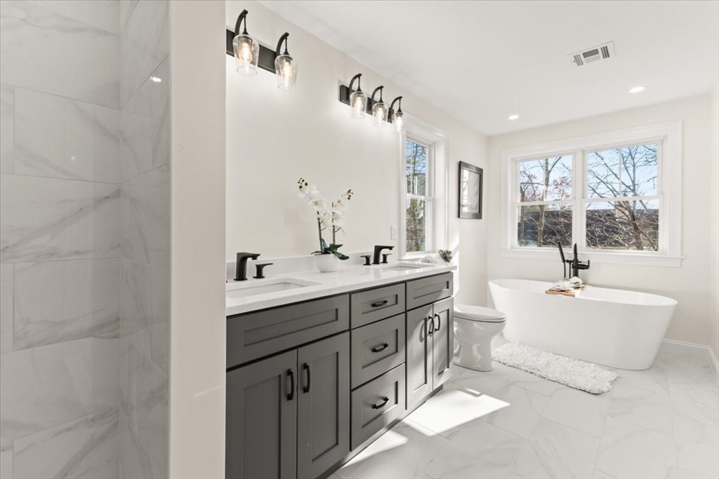 Lot 10 Matthew Circle Easton, MA 02356 - Photo 28 of 33 a spacious bathroom with double vanity a window a double vanity and a mirror
