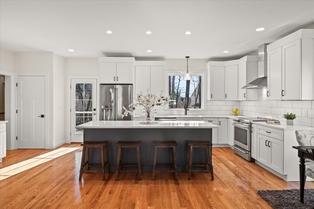 Lot 10 Matthew Circle Easton, MA 02356 - Photo 6 of 33 a kitchen with stainless steel appliances granite countertop a dining table chairs stove refrigerator and cabinets
