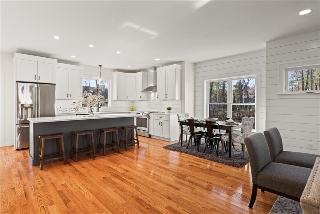 Lot 10 Matthew Circle Easton, MA 02356 - Photo 8 of 33 a kitchen with stainless steel appliances kitchen island granite countertop a dining table chairs and view living room